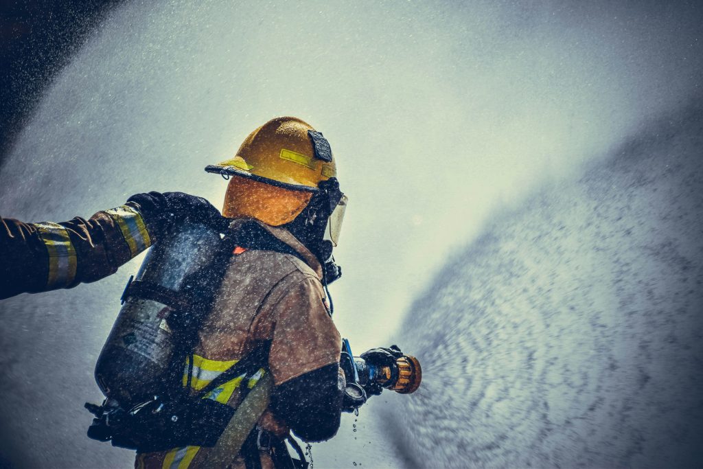 firefighter with an air atomizing spray nozzle